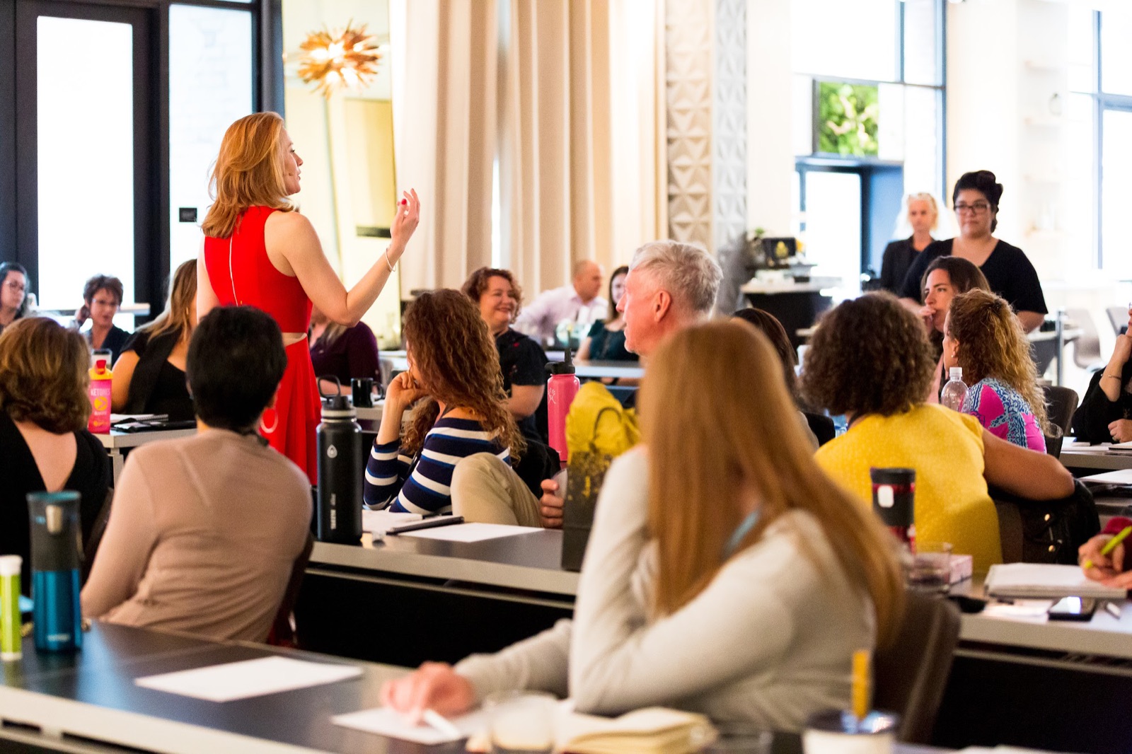 Tamara Rose teaching a full room of women at a live training