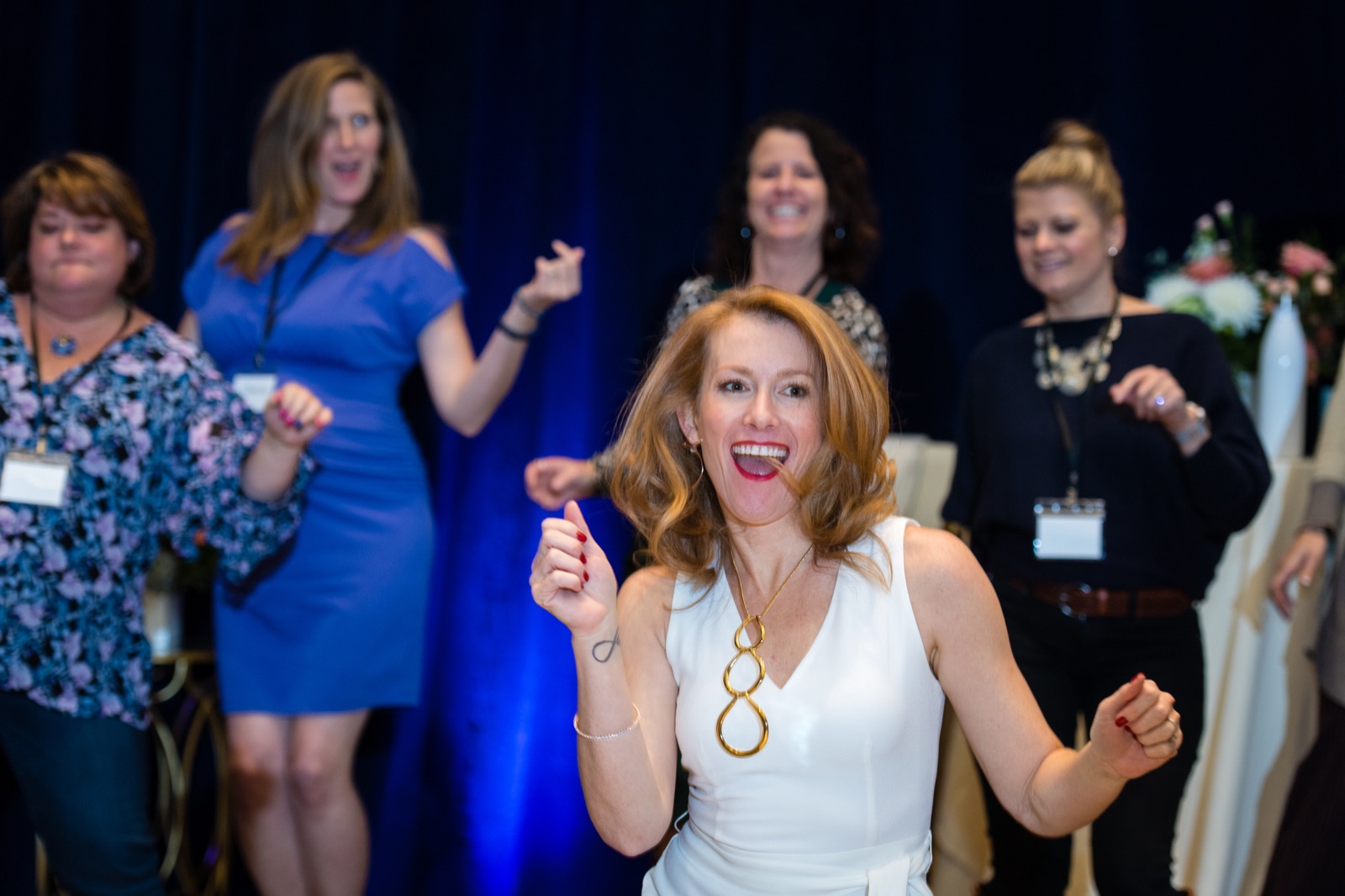 Tamara Rose dancing and laughing with women at a live event