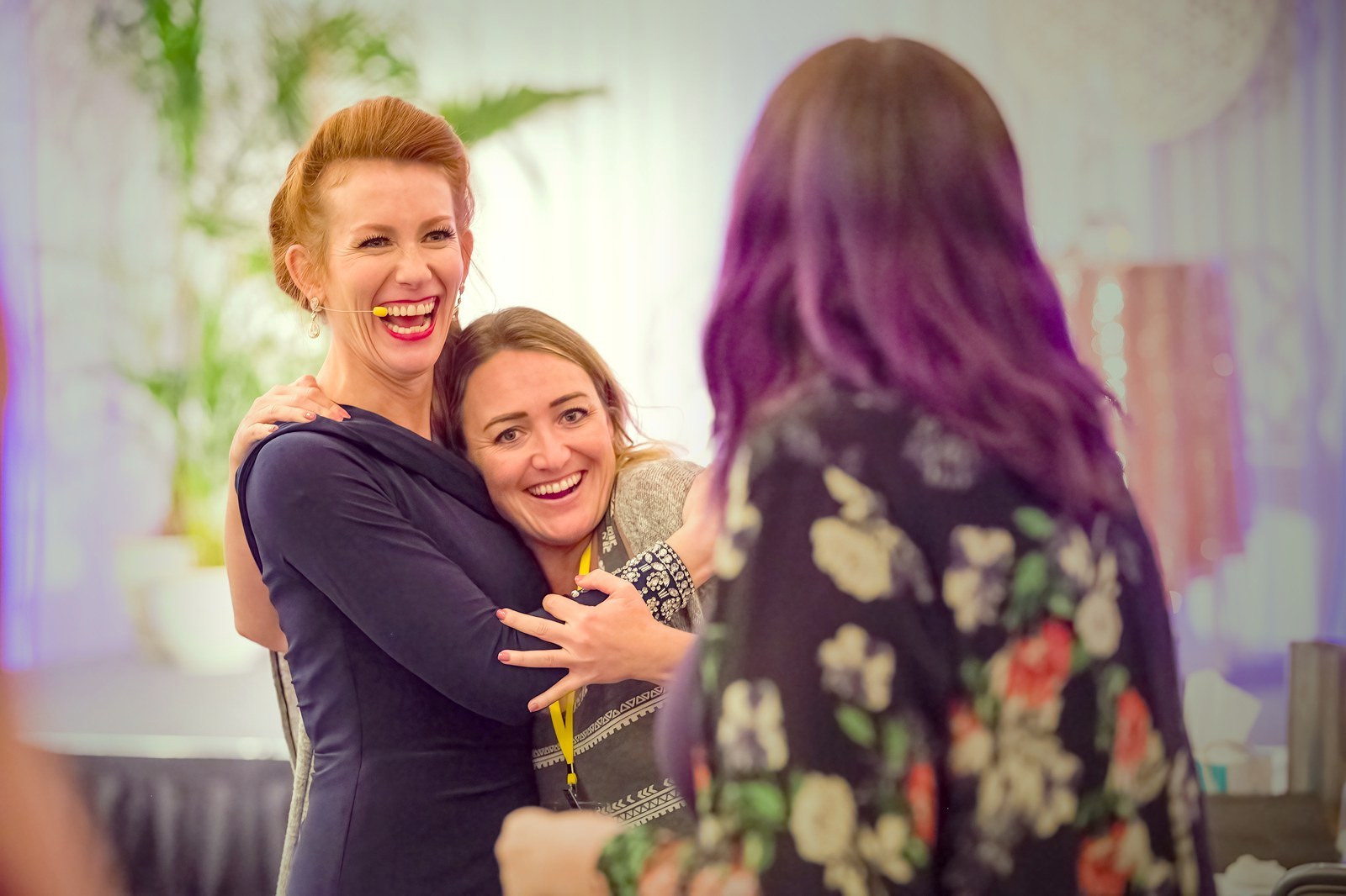 Tamara Rose hugging participants at a live event