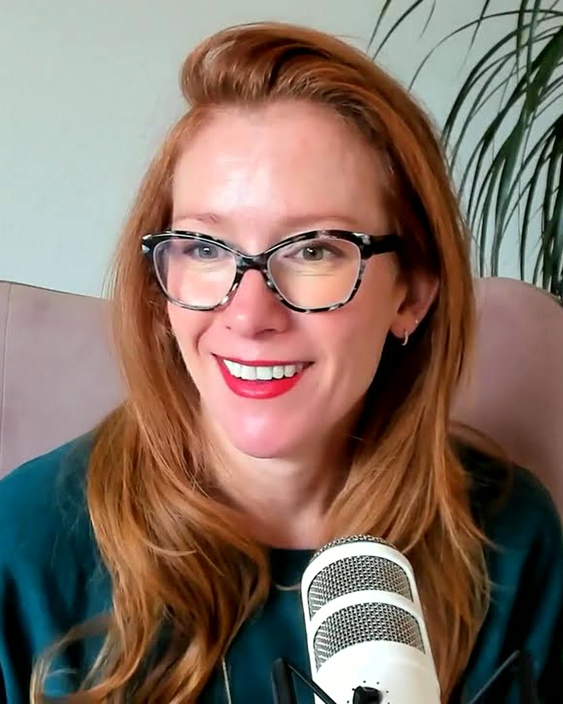 Tamara Rose smiling at the podcast microphone