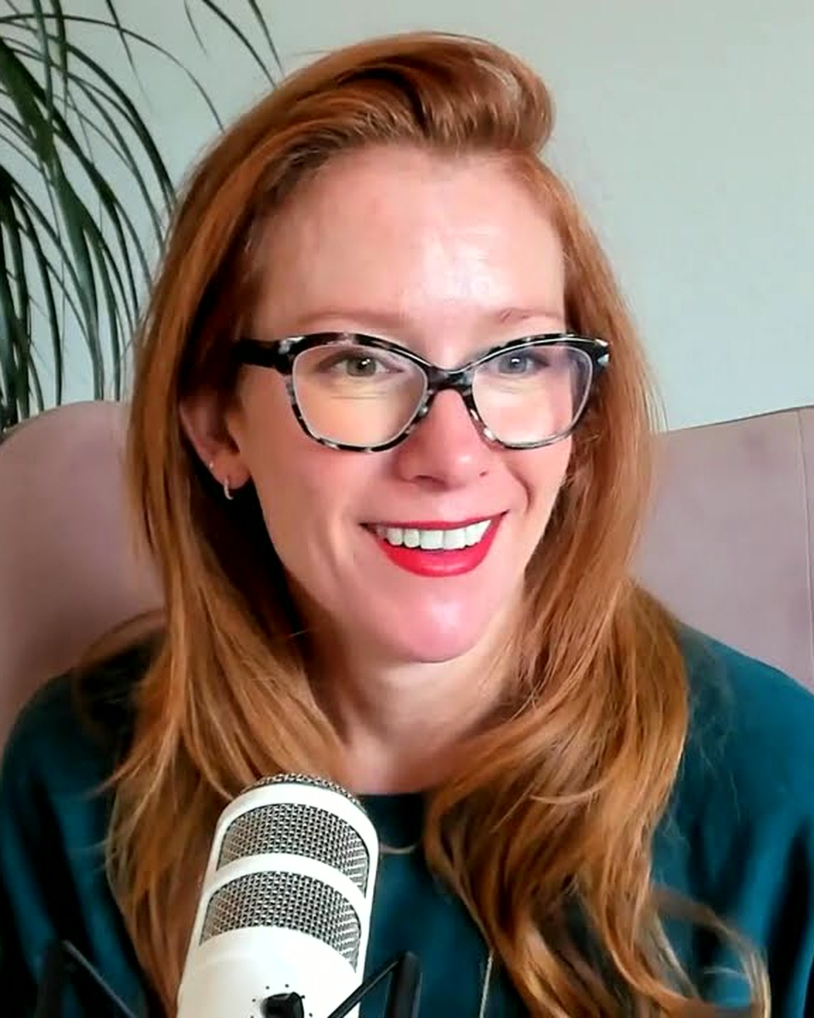 Tamara Rose smiling at the podcast microphone