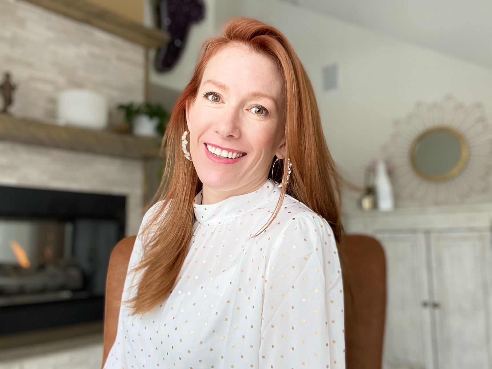 Tamara Rose smiling at home by the fireplace